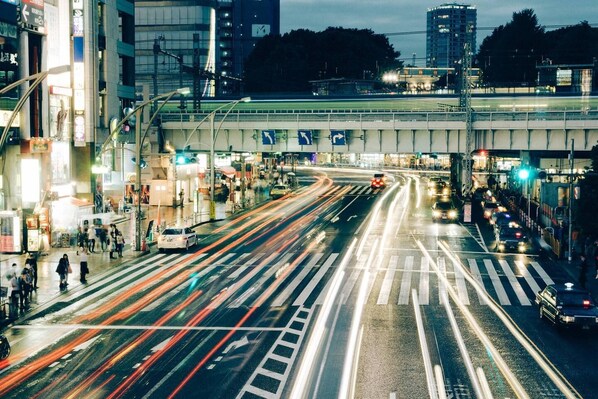 A busy urban intersection with multiple lanes and traffic lights.