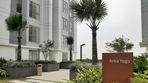 A modern building with a sign for 'Area Yoga'. - Comfortable 2BR Apartment Serpong M-Town Residence (Gading Serpong)