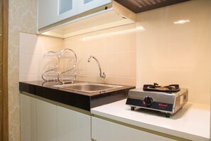 Room | Private kitchen | Fridge, stovetop, cookware/dishes/utensils - Homey Studio at The Oasis Cikarang Apartment (Cikarang)