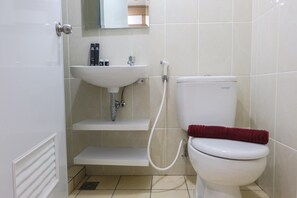 Bathroom features a pedestal sink, toilet, and showerhead.