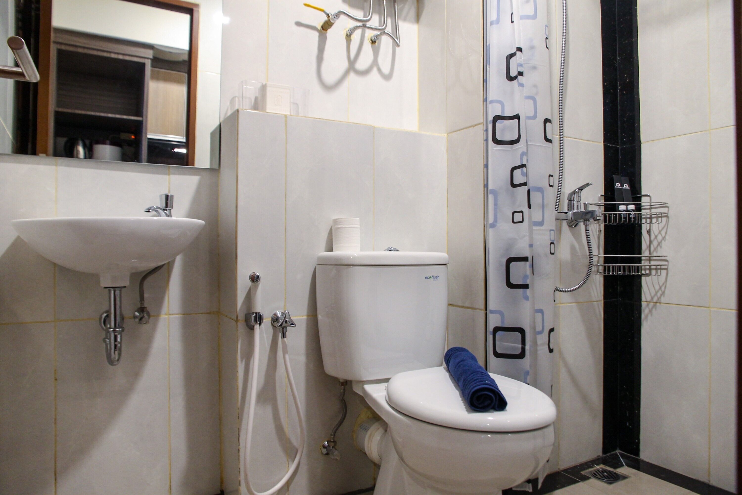 A bathroom with a sink, toilet, and shower.