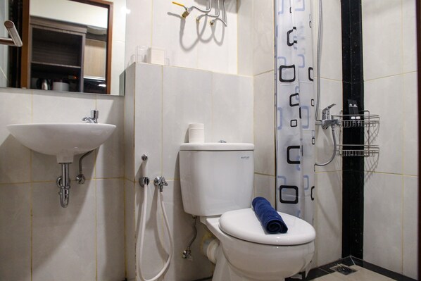 A bathroom with a sink, toilet, and shower.