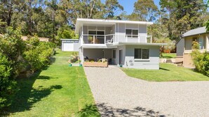 A two-story house with a covered porch, a garage, and a driveway leading to the front door. - Bay Breeze at Blenheim Beach, Vincentia (Vincentia)