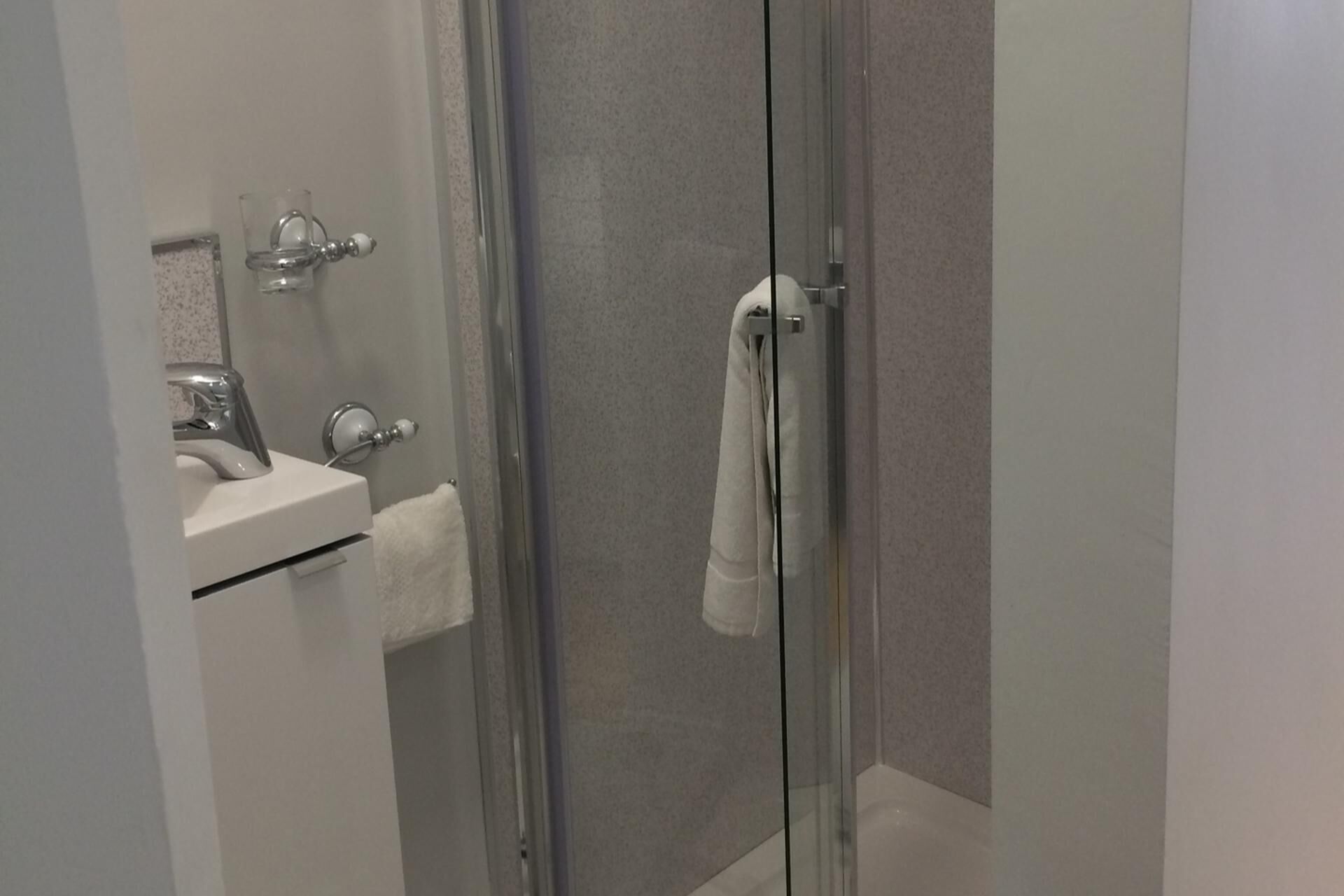 Shower, hair dryer, towels, shampoo