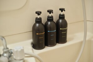 Three black bottles of Ella Bache hair treatment on a bathroom counter. - TORA Hotel Ueno 193D (Tokyo)