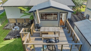 A two-story house with a deck, outdoor seating, and a barbecue grill. - Elaine at Hyams Beach, Jervis Bay (Hyams Beach)