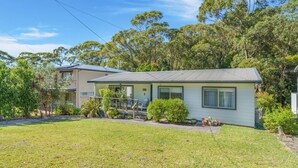 A two-story house with a front porch, a small deck, and a well-maintained lawn. - Elaine at Hyams Beach, Jervis Bay (Hyams Beach)