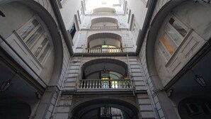 A multi-level building with arched balconies and a central entrance. - Skyhouse Duomo (Naples)
