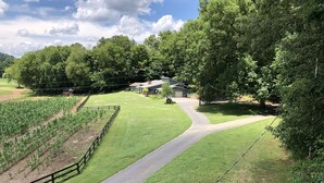 A rural landscape with a winding road, fields, and a house with a sloped roof. - The Cottage at Sunset View Estate.  Close to rafting, hiking, Dollywood 30 mins. (Cosby)