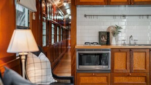 A kitchen with wooden cabinets, a microwave, and a book titled "Magnolia Tales".