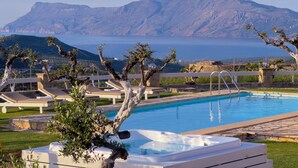 A pool with a hot tub, lounge chairs, and a view of mountains and the sea. - Traditional Fully Private Villa with Pool (Chania)