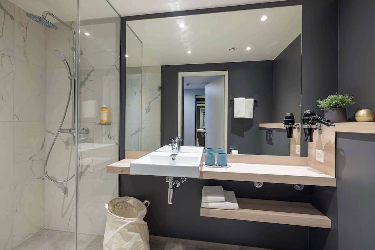 shower, hair dryer, towels, soap