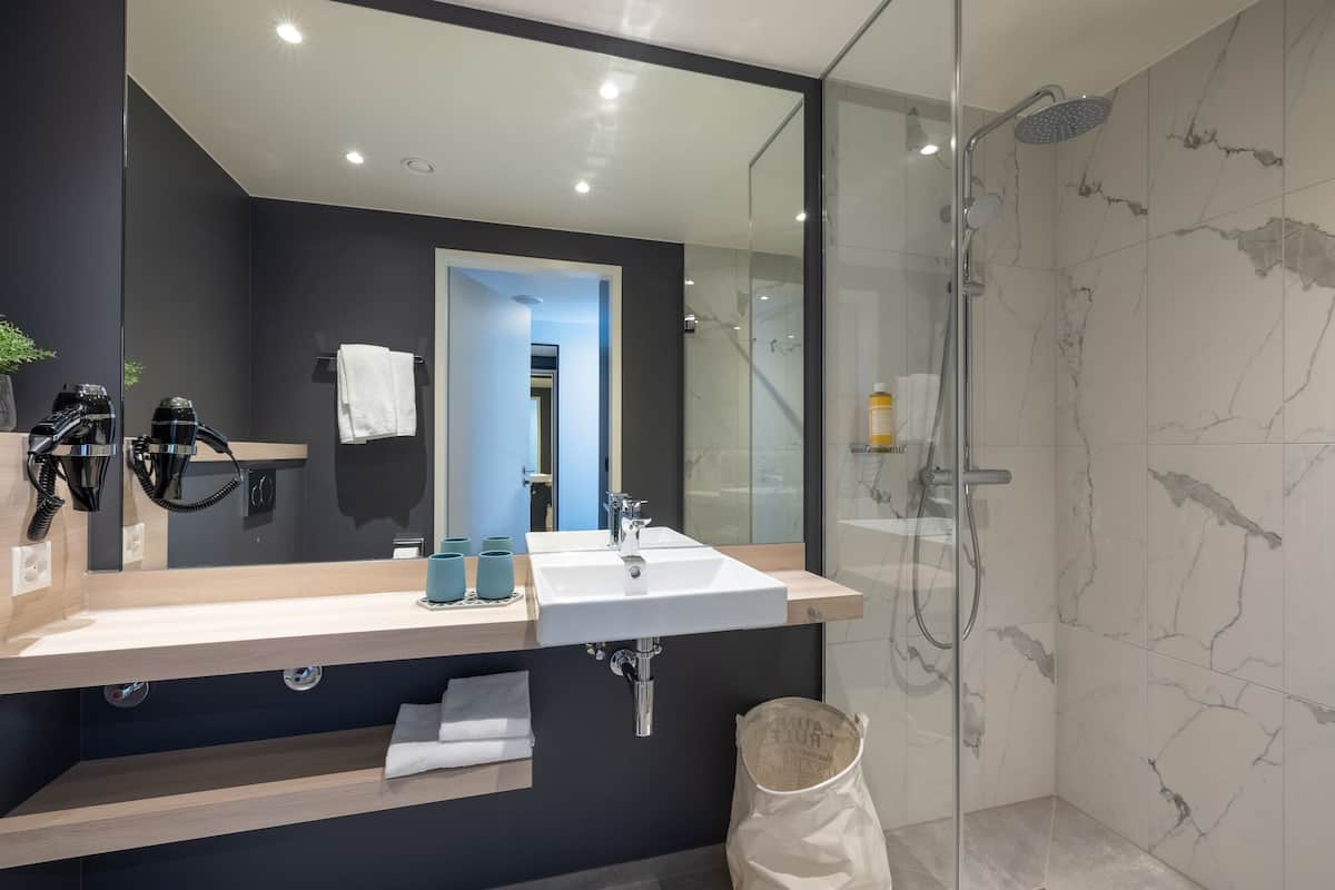 shower, hair dryer, towels, soap