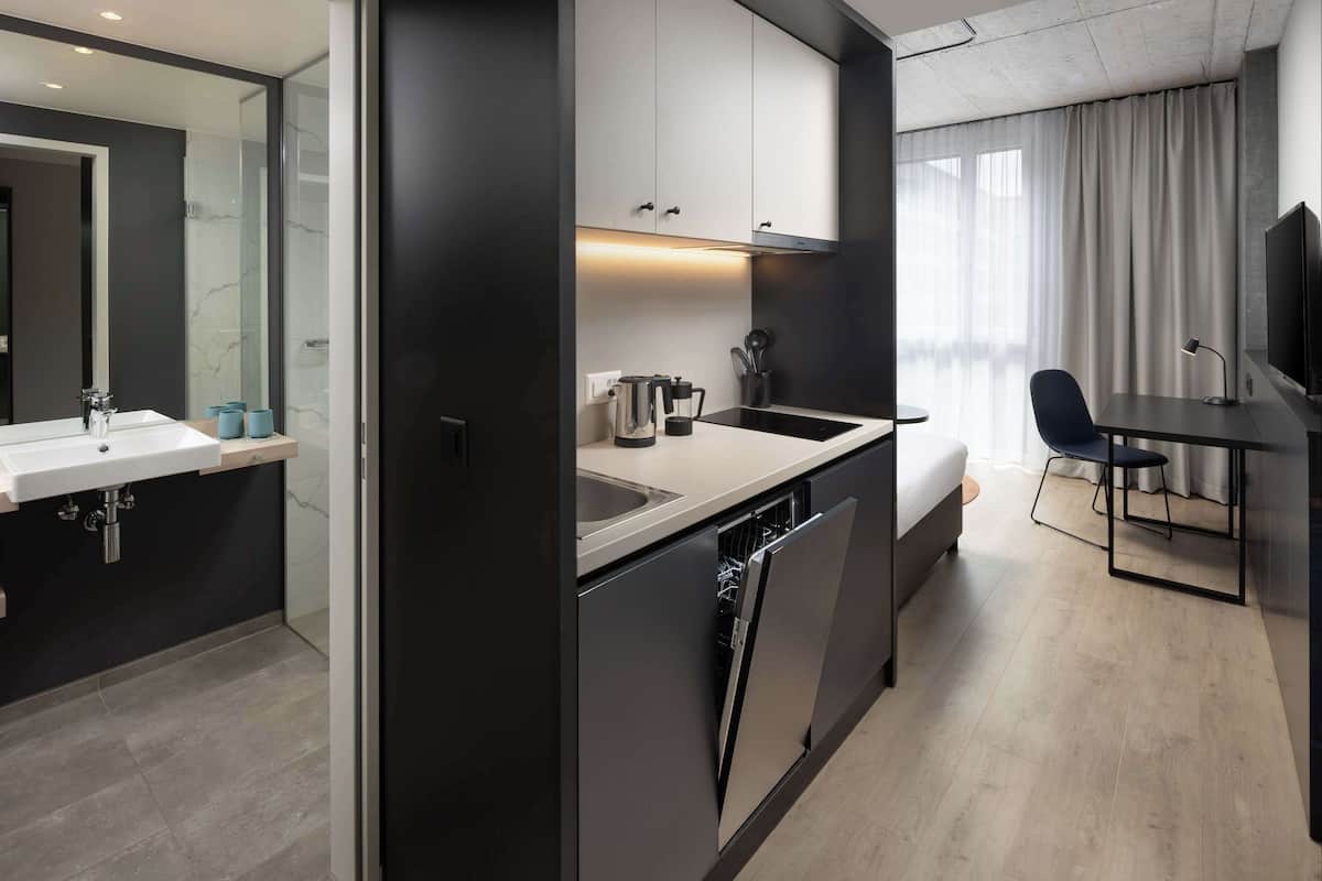 Premium bedding, desk, laptop workspace, blackout drapes