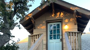 A wooden staircase leading to a door with a window, surrounded by a wooden deck. - Rustic Rooftop Delight - Bay Front 2 Bedroom Apts by RedAwning (Norfolk)
