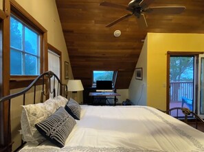 Relax in this cozy retreat with a large bed, desk, and balcony access.