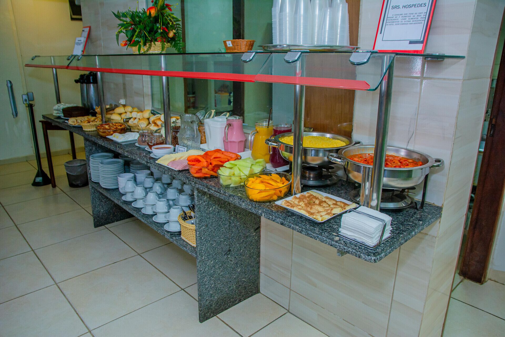 A buffet setup with various food items and beverages.