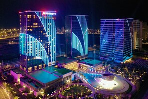 A modern hotel complex with illuminated architectural features, a central courtyard, and a circular fountain. - Fuzhou Marriott Hotel Riverside (Fuzhou)