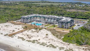 A modern hotel with multiple floors, a swimming pool, and a beach view. - Residence Inn by Marriott Jekyll Island (Jekyll Island)