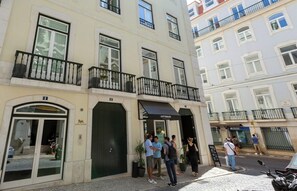 A building with multiple floors, balconies, and a ground-level entrance.