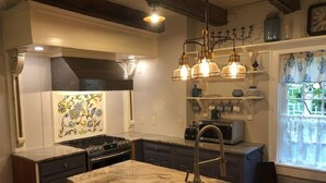 A modern kitchen with a central island, stainless steel appliances, and pendant lighting. - Charmingly renovated historic Canal House on C&O along Potomac close to Antietam (Sharpsburg)