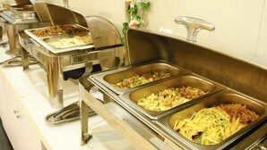 A buffet setup with multiple stainless steel serving trays containing various dishes. - Greentree Alliance Shanghai Railway Station Qiujiang Road Hotel (Shanghai)