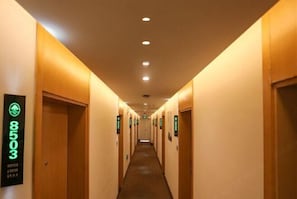 A hotel hallway with doors numbered 8503, featuring a carpeted floor and recessed lighting. - Greentree Inn (Xuzhou Railway Station) (Xuzhou)