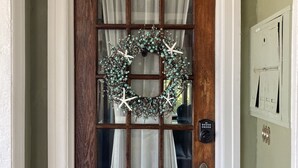A wooden door with a glass panel, a wreath, and the number 101 above it. - Historic Luxury Condo with POOL & modern amenities in Wildwood Crest, NJ   (Wildwood Crest)