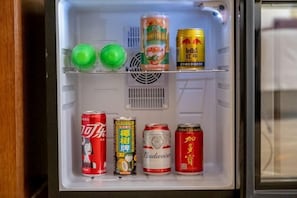A refrigerator with various beverages including Coca-Cola, Budweiser, and Red Bull. - Ruiting Hotel (Zhongshan Xiaolan Daxin Xinduhui Branch) (Zhongshan)
