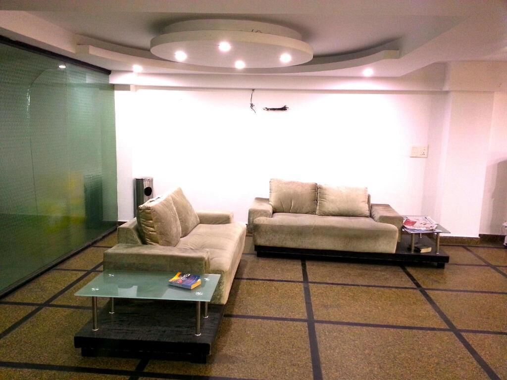 A modern living room with two sofas, a coffee table, and a small side table.