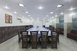 A conference room with a long table, chairs, a whiteboard, and a projector. - Kingston Park (New Delhi)