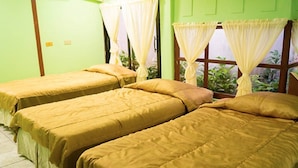 A room with two single beds, each with a yellow bedspread and white curtains. - Grecia Real Hotel (San Salvador)