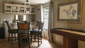 A dining area with wooden chairs and a pool table. - Secluded Wildlife Ranch. Kayak on Colorado River. Feed Exotics. (Lometa)