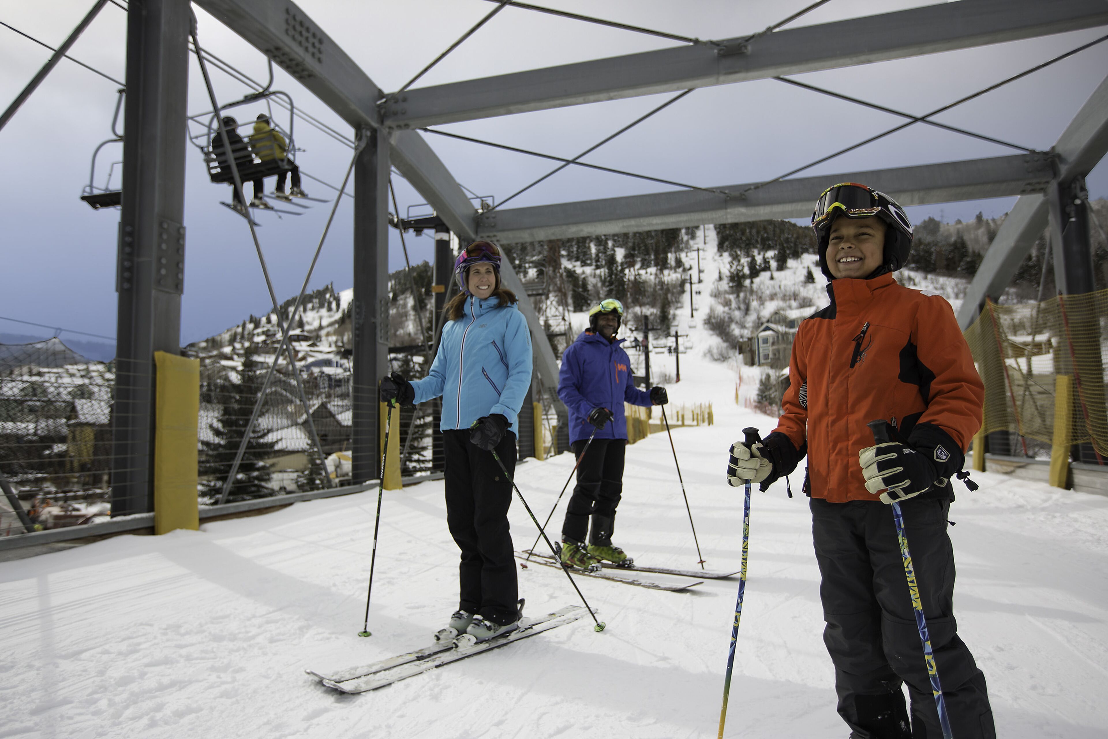 A ski lift with skiers in the background.