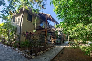 Relax on the balcony surrounded by lush greenery and enjoy the serene atmosphere.