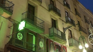 A multi-story building with balconies and a street lamp. - MH Apartments Opera Rambla (Barcelona)