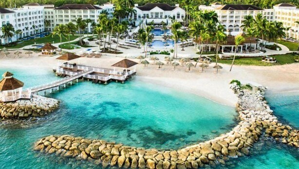A resort with overwater bungalows, a central pool, and a beach area. - Hyatt Zilara Rose Hall - Adults Only (Montego Bay)
