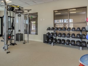 A gym with weightlifting equipment and a rack of dumbbells. - Doubletree by Hilton Phoenix Chandler (Chandler)