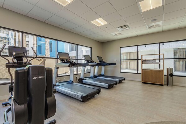 A gym with treadmills, a stationary bike, and a rowing machine. - Doubletree by Hilton Phoenix Chandler (Chandler)