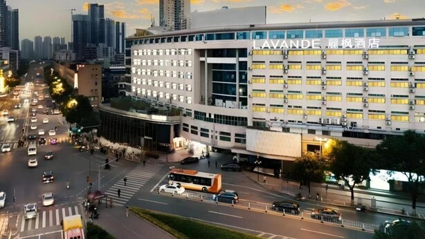 A modern hotel building with multiple floors and a prominent entrance. - Lavande Hotels (Guangzhou)