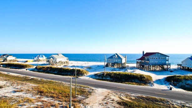 A coastal road with beach houses on stilts. - Second Wind - 2612 Bienville Blvd (Dauphin Island)
