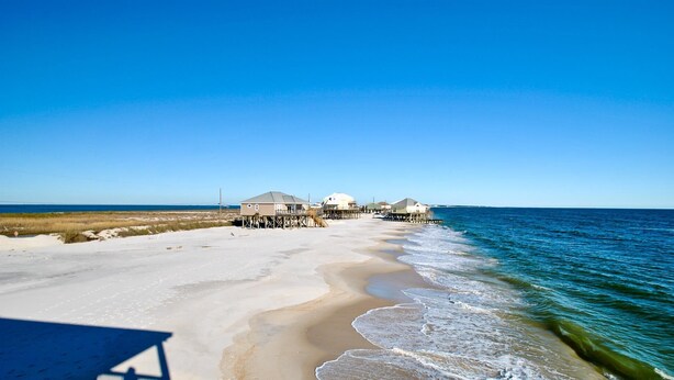 A beachfront property with multiple houses connected by wooden walkways over the water. - West Beach - 104 Westward Ho (Dauphin Island)