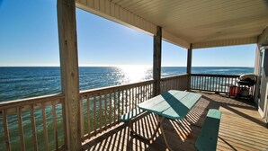 A wooden deck with a table and benches overlooking the ocean. - West Beach - 104 Westward Ho (Dauphin Island)