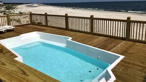 A wooden deck with a rectangular hot tub overlooking a beach. - Island Time IV - 101 Pushmatah (Dauphin Island)