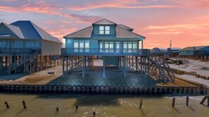 A waterfront house with a balcony, wooden deck, and a view of the water. - Tramarlis - 2254 Sandpiper (Dauphin Island)