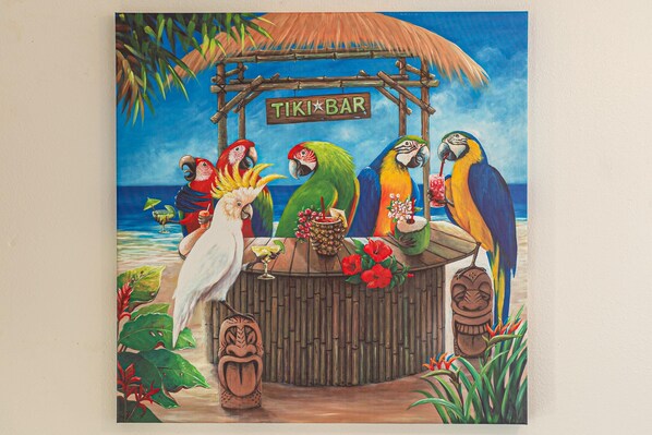 A tiki bar with a thatched roof and a sign reading "TIKI BAR".