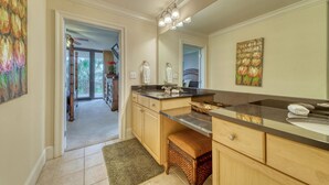 A modern bathroom with a large mirror, a double sink, and a walk-in shower. - Holiday Isle #122 (Dauphin Island)
