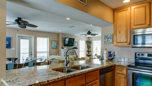 A kitchen with wooden cabinets, a built-in oven, and a dishwasher.