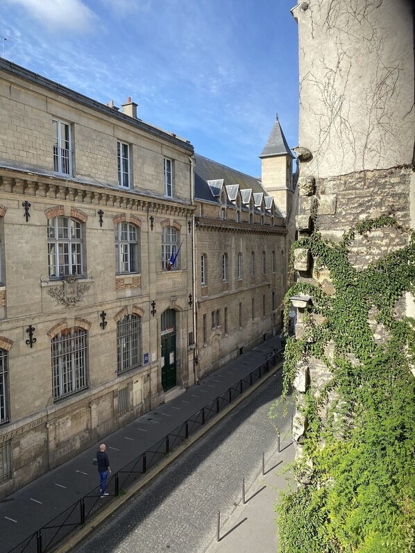 A historic building with a stone facade, arched windows, and a central entrance.