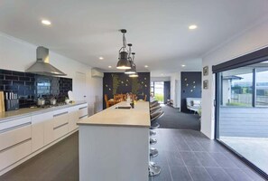 Enjoy cooking in this kitchen with a sink, ample counter space, and a stylish light fixture.